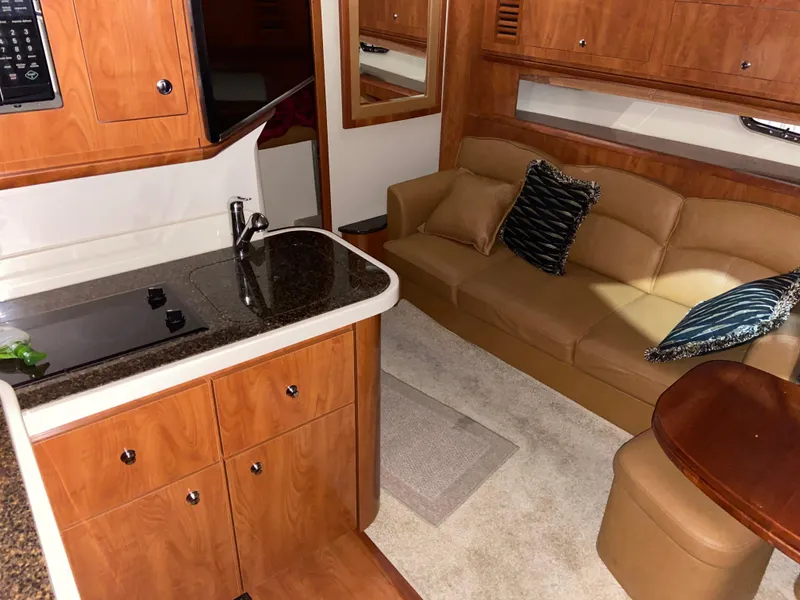 Slide: The Image of Interior of 2006 Four Winns 378 Vista yacht with kitchen and cozy seating area. - 5
