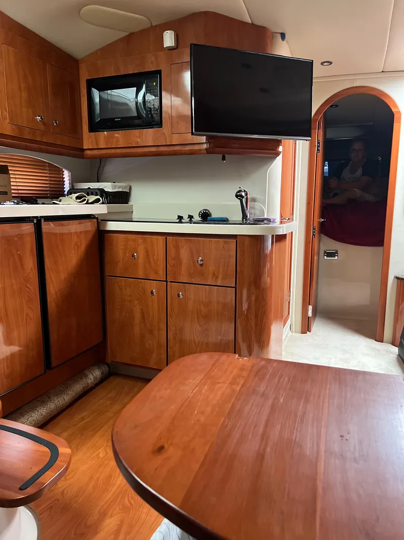 Slide: The Image of Interior of 2006 Four Winns 378 Vista yacht with wood cabinetry and modern amenities. - 6