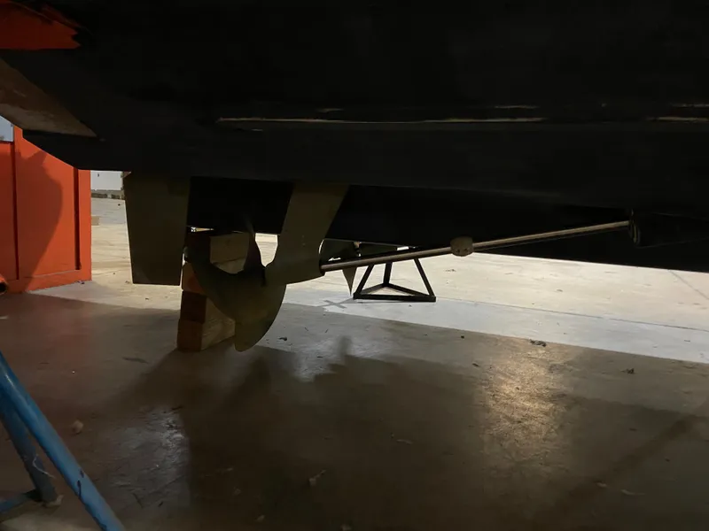 Slide: The Image of 2006 Four Winns 378 Vista boat propeller and shaft in a workshop setting. - 8