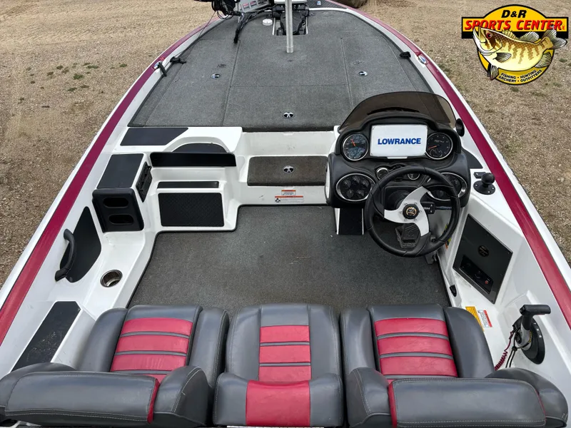 Slide: The Image of 2009 Triton 18X3 SC boat interior with Lowrance system and red-gray seating. - 4