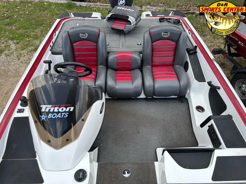 Slide: The Image of 2009 Triton 18X3 SC boat interior with red and gray seating, steering wheel, and dashboard. - 6
