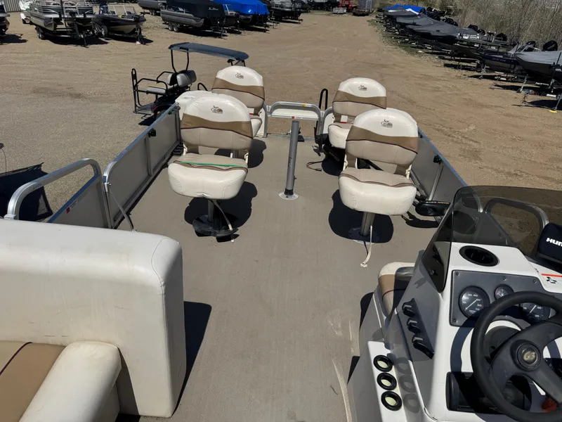 Slide: The Image of 2008 G3 SunCatcher 228 F&C Vinyl boat interior with seating and steering console. - 17