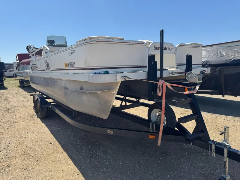 Slide: The Image of 2008 G3 SunCatcher 228 F&C Vinyl pontoon boat on trailer, outdoor setting. - 2