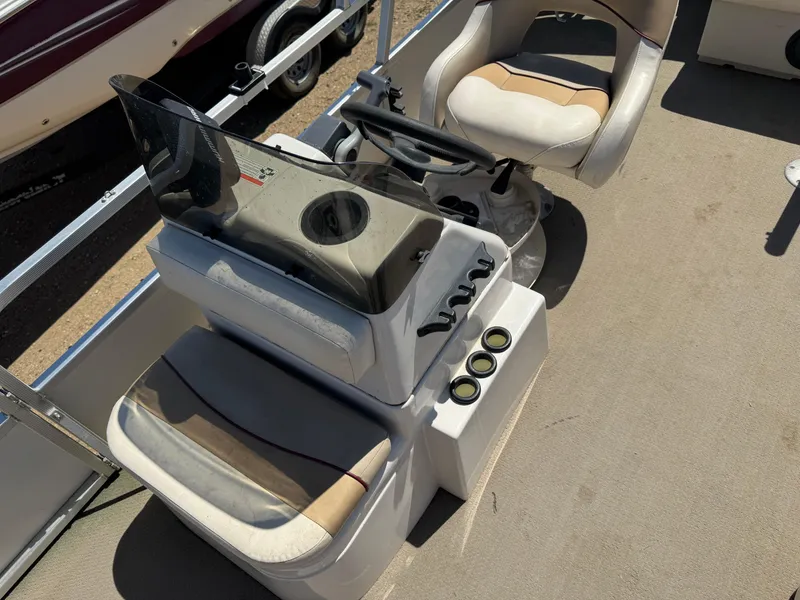 Slide: The Image of 2008 G3 SunCatcher 228 F&C Vinyl boat interior with steering console and seating. - 12