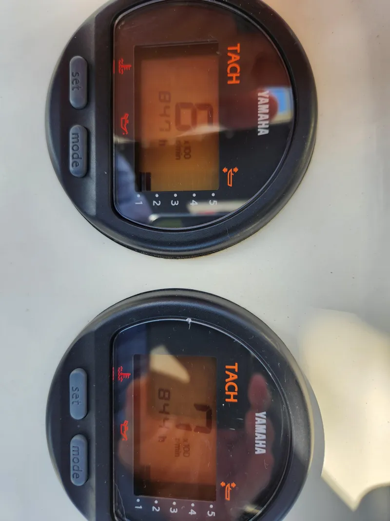 Slide: The Image of Close-up of Yamaha tachometers on a 2004 Pursuit 2470 Center Console boat. - 8
