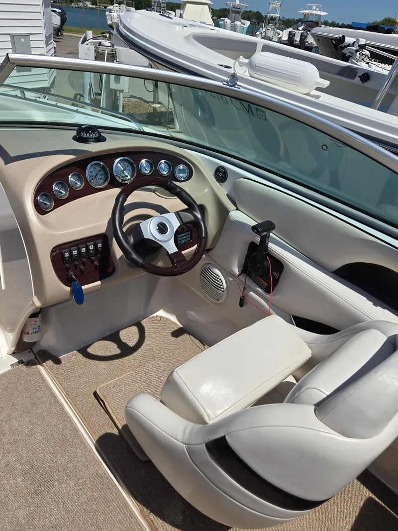 Slide: The Image of Interior of a 2000 Chaparral 196 SSi boat, featuring steering wheel and dashboard controls. - 4