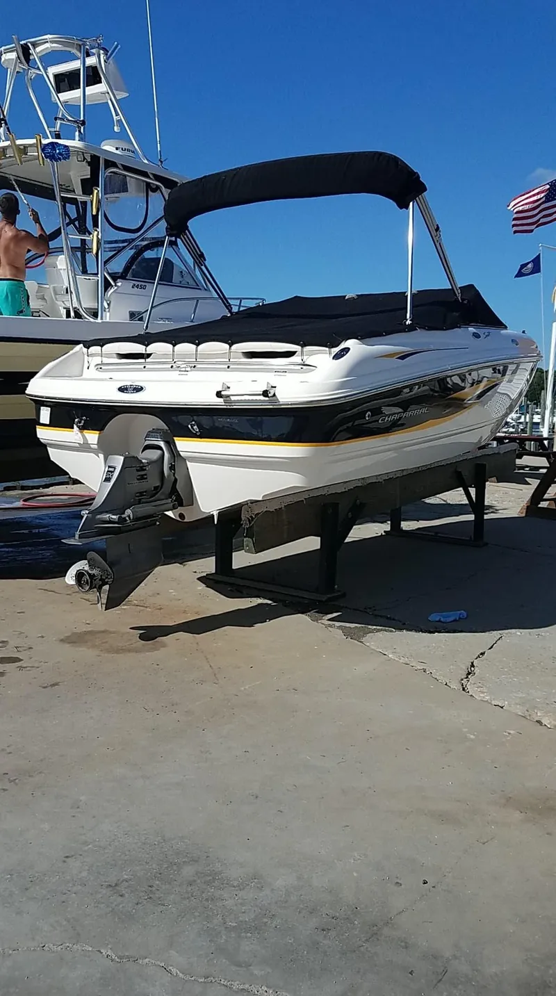 Slide: The Image of Chaparral 196 SSi 2000 boat on stand, marina setting, clear blue sky. - 8
