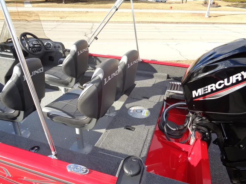 Slide: The Image of 2025 Lund 1650 Rebel XL SS boat interior with Mercury engine, featuring four seats. - 14