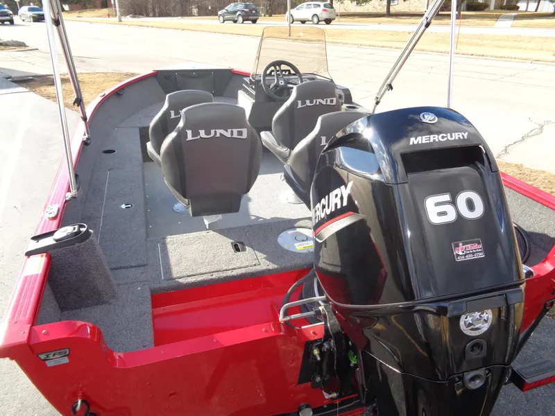 Slide: The Image of 2025 Lund 1650 Rebel XL SS boat with Mercury 60 engine, red exterior, and spacious seating. - 16