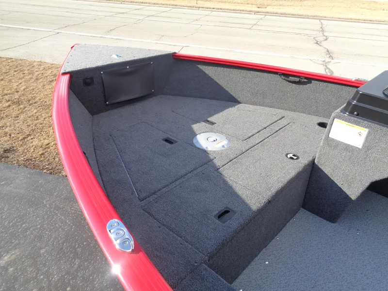 Slide: The Image of 2025 Lund 1650 Rebel XL SS boat deck with red trim and storage compartments. - 19