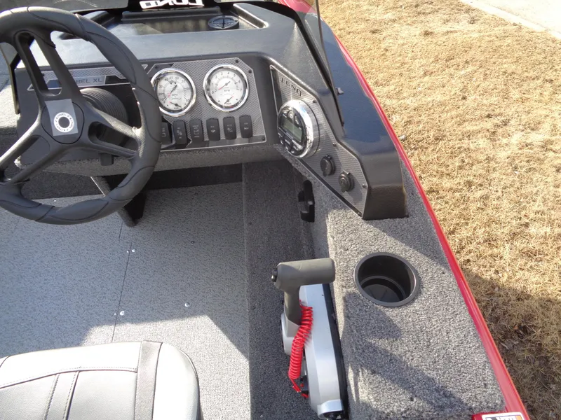 Slide: The Image of 2025 Lund 1650 Rebel XL SS boat dashboard with steering wheel and control panel. - 21