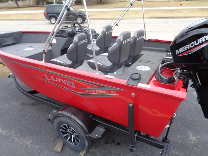 Slide: The Image of 2025 Lund 1650 Rebel XL SS boat, red exterior, Mercury engine, on trailer, side view. - 6