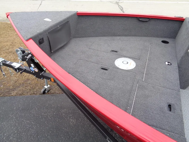 Slide: The Image of 2025 Lund 1650 Rebel XL SS boat deck with red trim and storage compartments. - 8