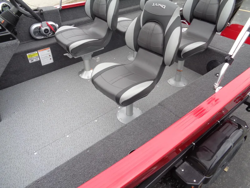 Slide: The Image of 2025 Lund 1650 Rebel XL SS boat interior with gray seating and red accents. - 9