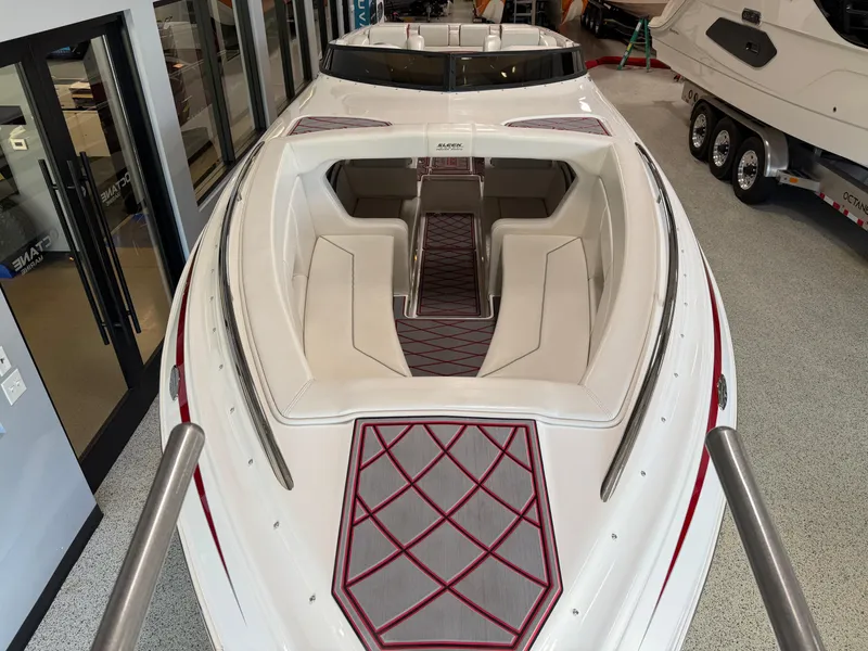 Slide: The Image of 2006 Sleekcraft Heritage boat with red accents and spacious seating in showroom. - 10