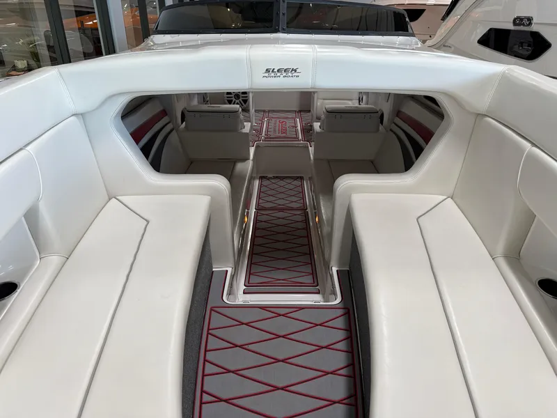 Slide: The Image of 2006 Sleekcraft Heritage boat interior with white seating and red-accented flooring. - 11