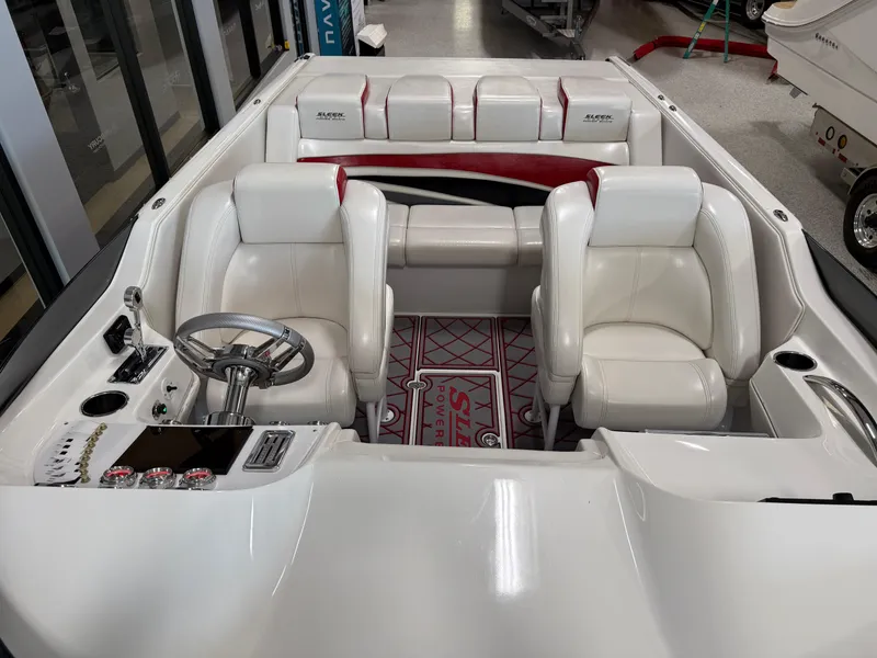 Slide: The Image of 2006 Sleekcraft Heritage boat interior with white leather seats and modern dashboard. - 16