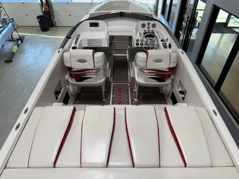 Slide: The Image of 2006 Sleekcraft Heritage boat interior with white and red seating, modern dashboard. - 28