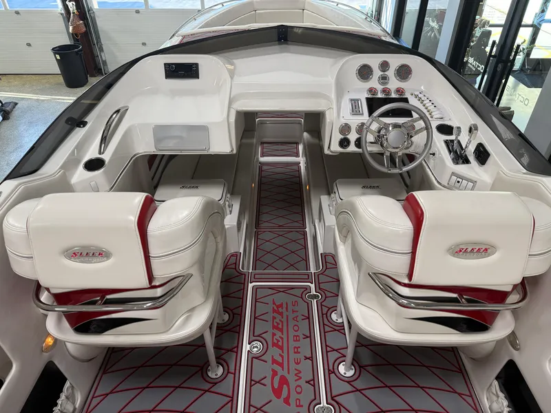 Slide: The Image of 2006 Sleekcraft Heritage boat interior with white and red seating, modern dashboard, and sleek design. - 29