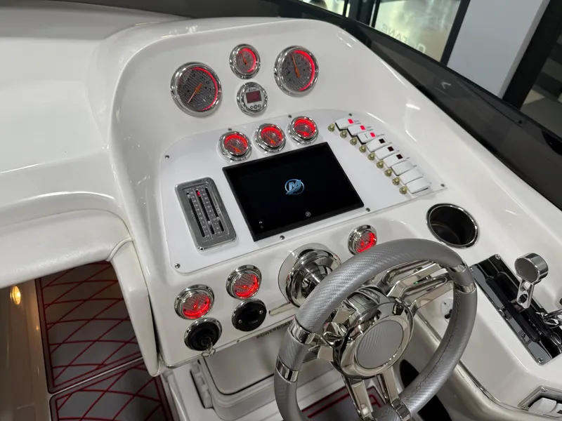 Slide: The Image of 2006 Sleekcraft Heritage boat dashboard with gauges, steering wheel, and control panel. - 31