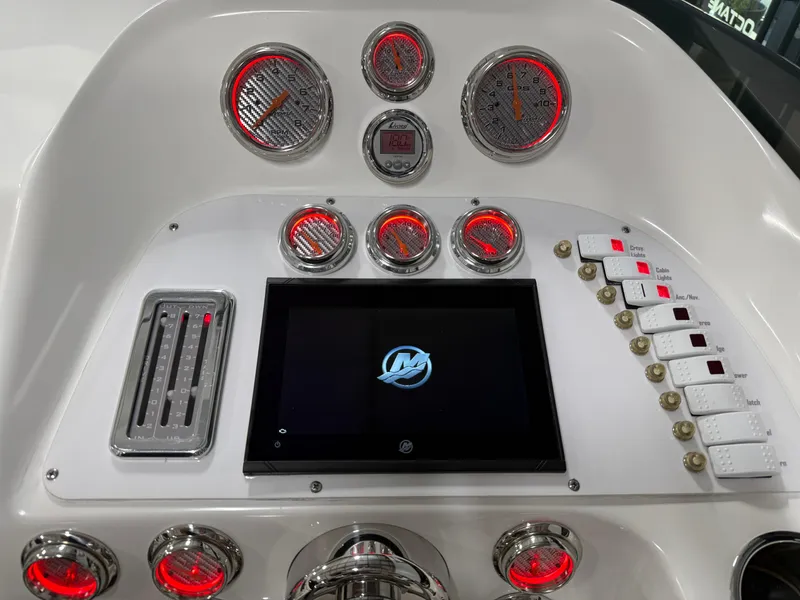 Slide: The Image of Dashboard of 2006 Sleekcraft Heritage boat with illuminated gauges and control panel. - 32