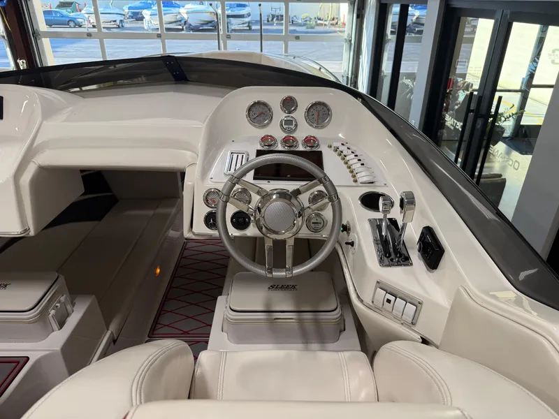 Slide: The Image of 2006 Sleekcraft Heritage boat cockpit with steering wheel and control panel. - 33