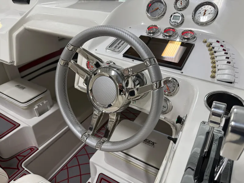 Slide: The Image of 2006 Sleekcraft Heritage boat dashboard with chrome steering wheel and modern gauges. - 34