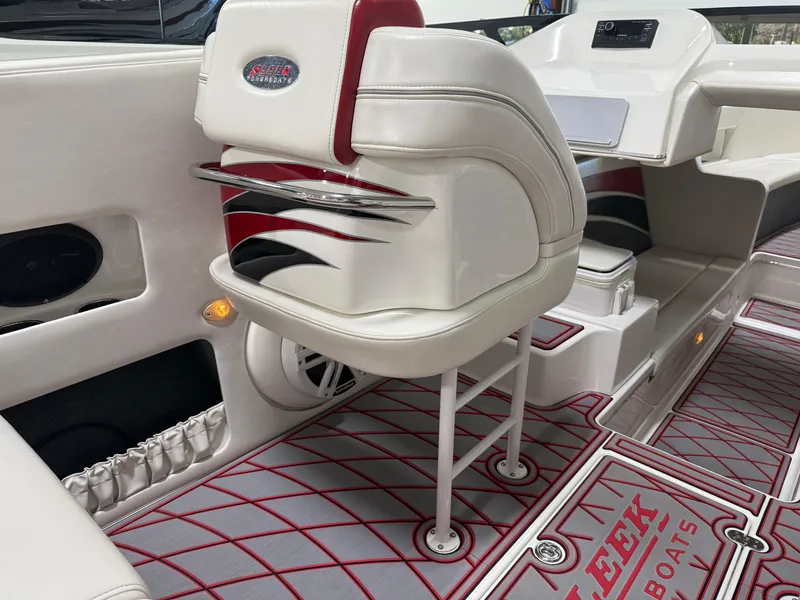 Slide: The Image of Interior of a 2006 Sleekcraft Heritage boat with stylish seating and red accents. - 37