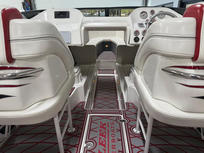 Slide: The Image of 2006 Sleekcraft Heritage boat interior with white and red seating, modern dashboard, and custom flooring. - 38