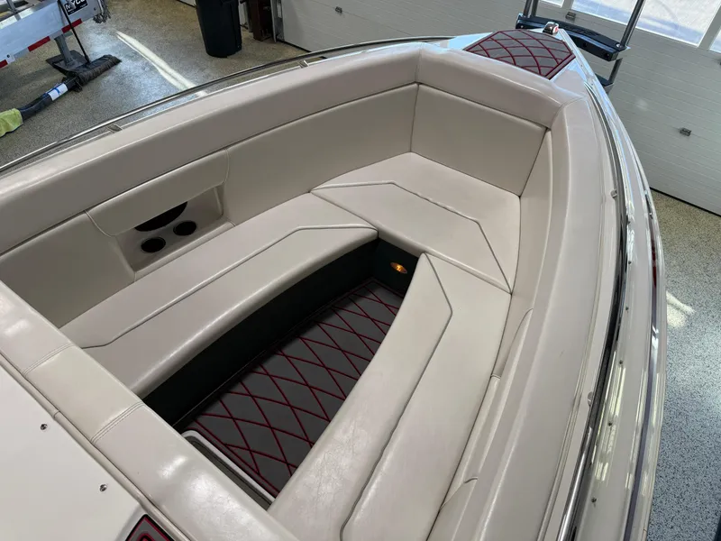 Slide: The Image of 2006 Sleekcraft Heritage boat interior with white cushioned seating and red accents. - 43
