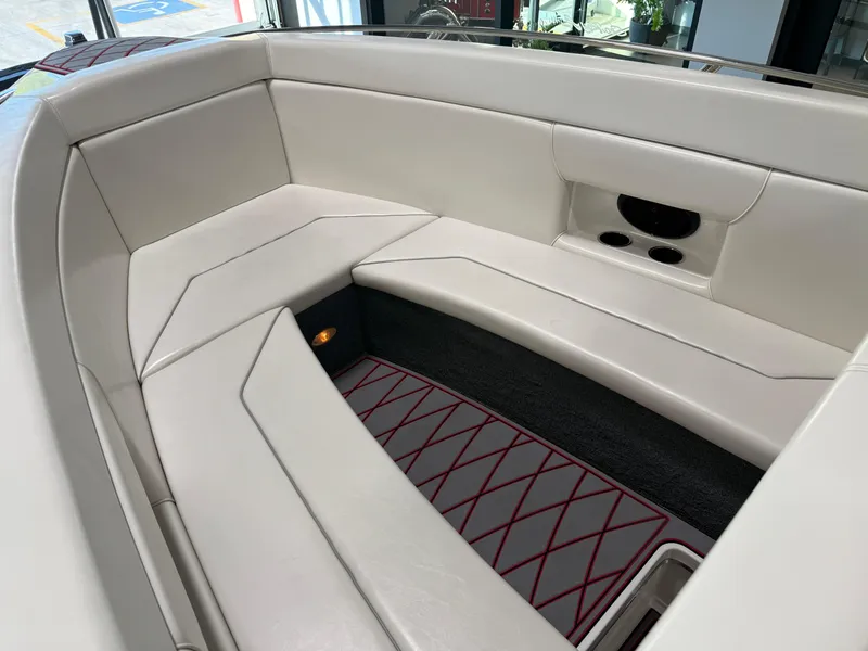 Slide: The Image of 2006 Sleekcraft Heritage boat interior with white cushioned seating and red-accented flooring. - 44