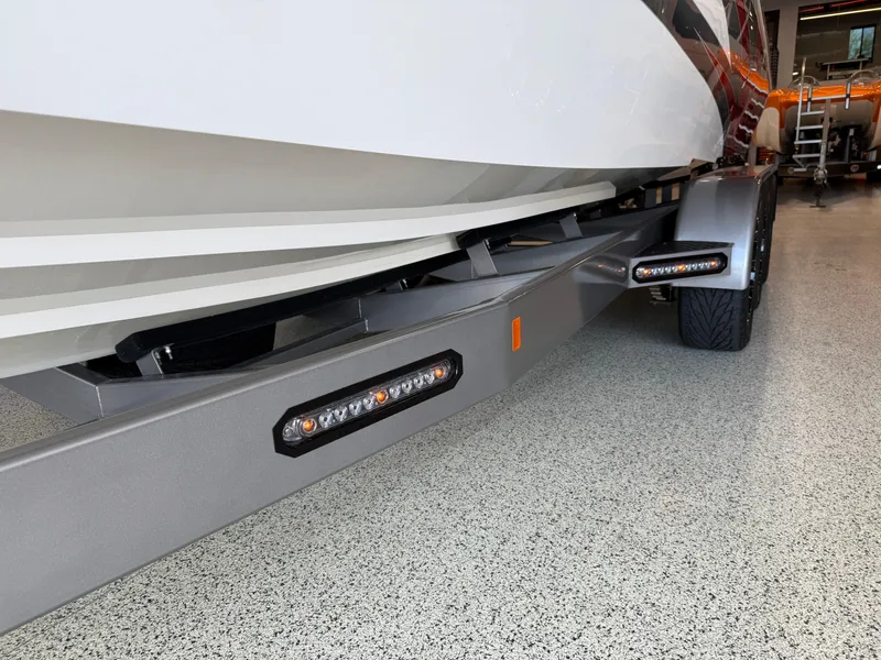 Slide: The Image of 2006 Sleekcraft Heritage boat on trailer with LED lights in a garage. - 45