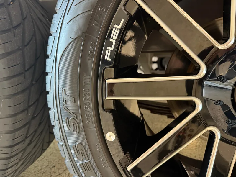 Slide: The Image of Close-up of a 2006 Sleekcraft Heritage tire and black alloy wheel. - 47