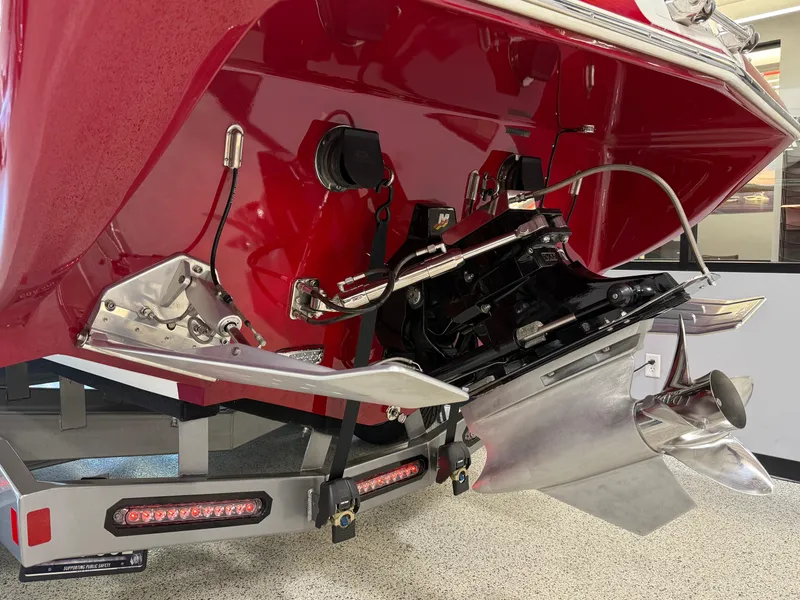 Slide: The Image of 2006 Sleekcraft Heritage boat stern with propeller and trim tabs in a garage. - 7