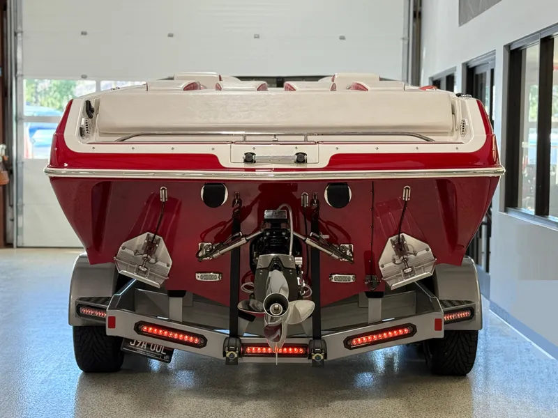 Slide: The Image of 2006 Sleekcraft Heritage boat on trailer, rear view in garage setting. - 8