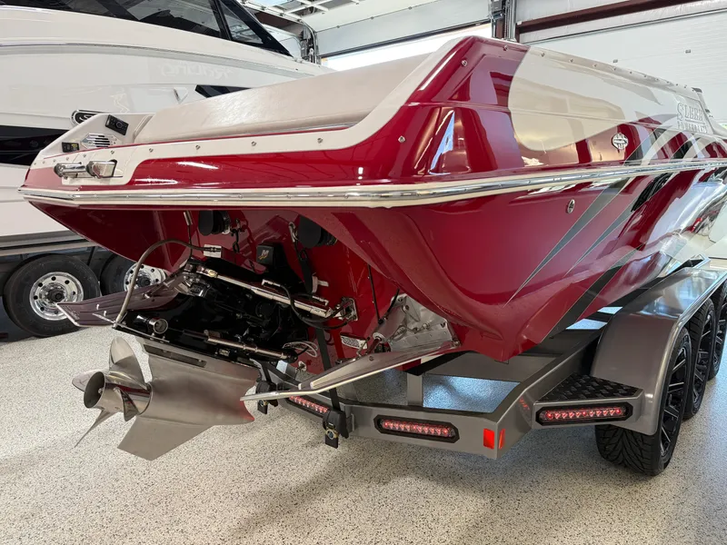 Slide: The Image of 2006 Sleekcraft Heritage boat on trailer, red and white design, rear view in garage. - 9