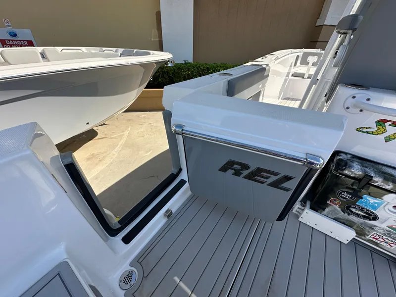 Slide: The Image of 2021 Release 240 RX boat interior with open storage compartment and sleek design. - 10