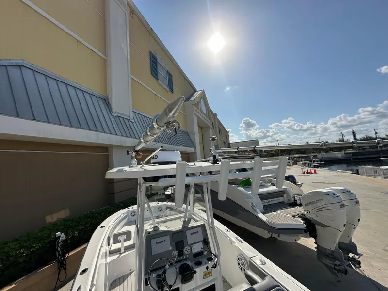 Slide: The Image of 2021 Release 240 RX boat docked under sunny sky near a building. - 11
