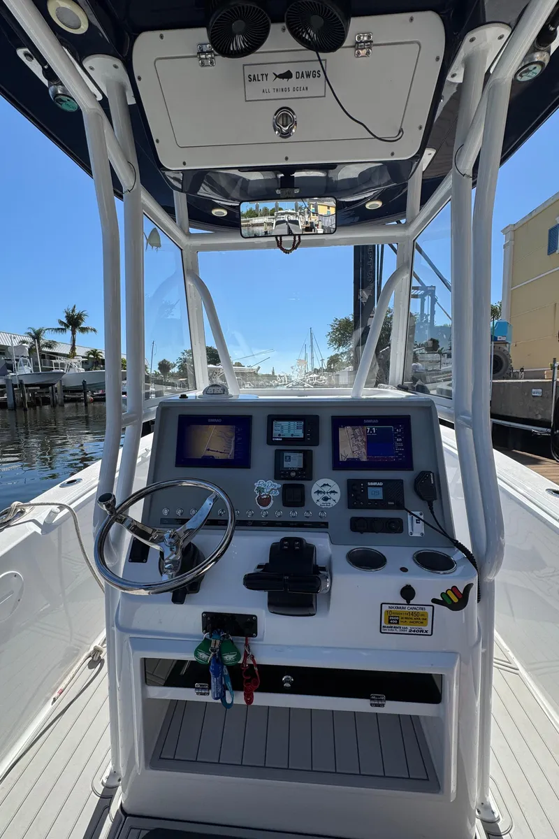 Slide: The Image of Center console of 2021 Release 240 RX boat with navigation screens and controls. - 18