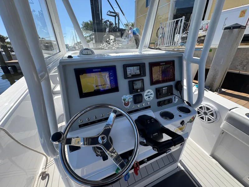 Slide: The Image of 2021 Release 240 RX boat dashboard with navigation screens and steering wheel. - 19