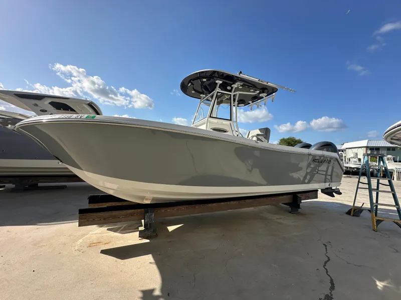 Slide: The Image of 2021 Release 240 RX boat on display under clear blue sky. - 2