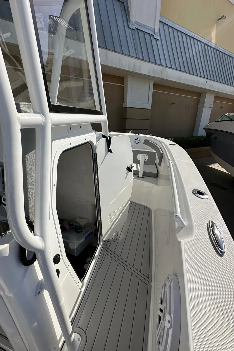Slide: The Image of 2021 Release 240 RX boat with sleek white deck and modern design. - 21