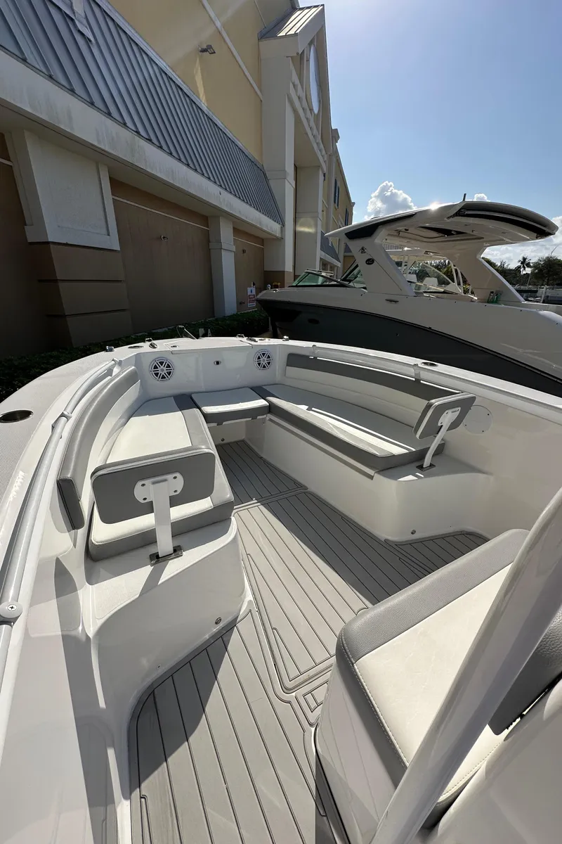 Slide: The Image of 2021 Release 240 RX boat with spacious seating and modern design, docked outdoors. - 24