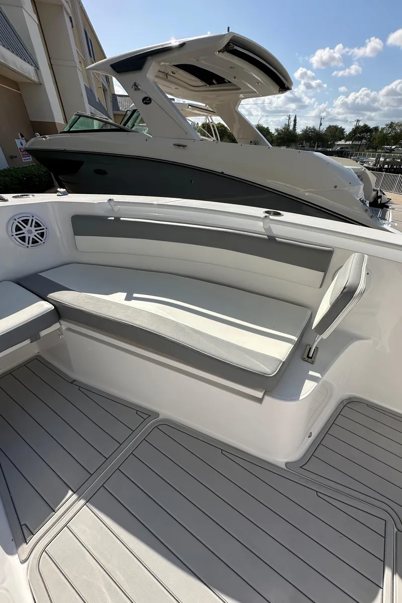 Slide: The Image of 2021 Release 240 RX boat interior with cushioned seating and sleek design. - 29
