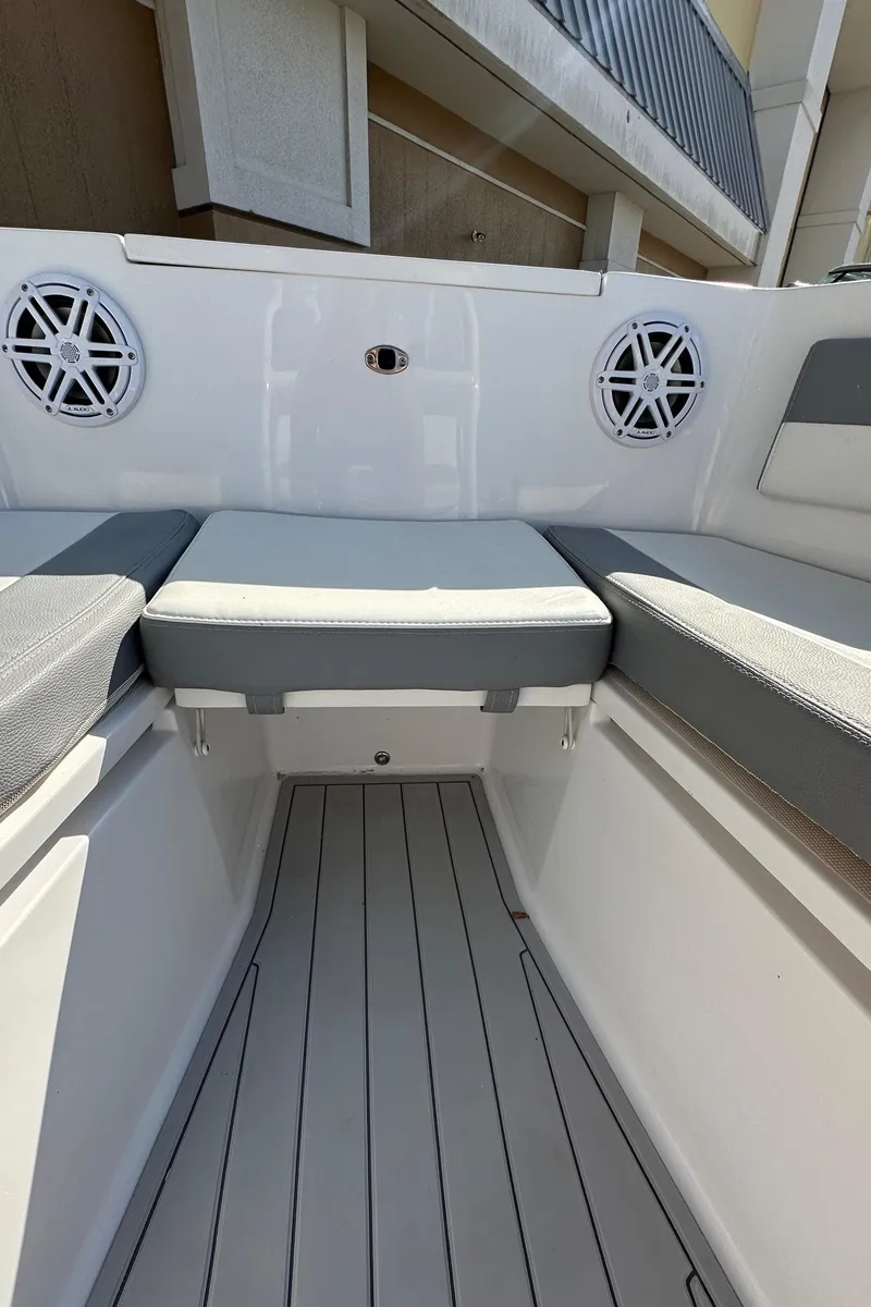 Slide: The Image of 2021 Release 240 RX boat interior with cushioned seating and speakers. - 32