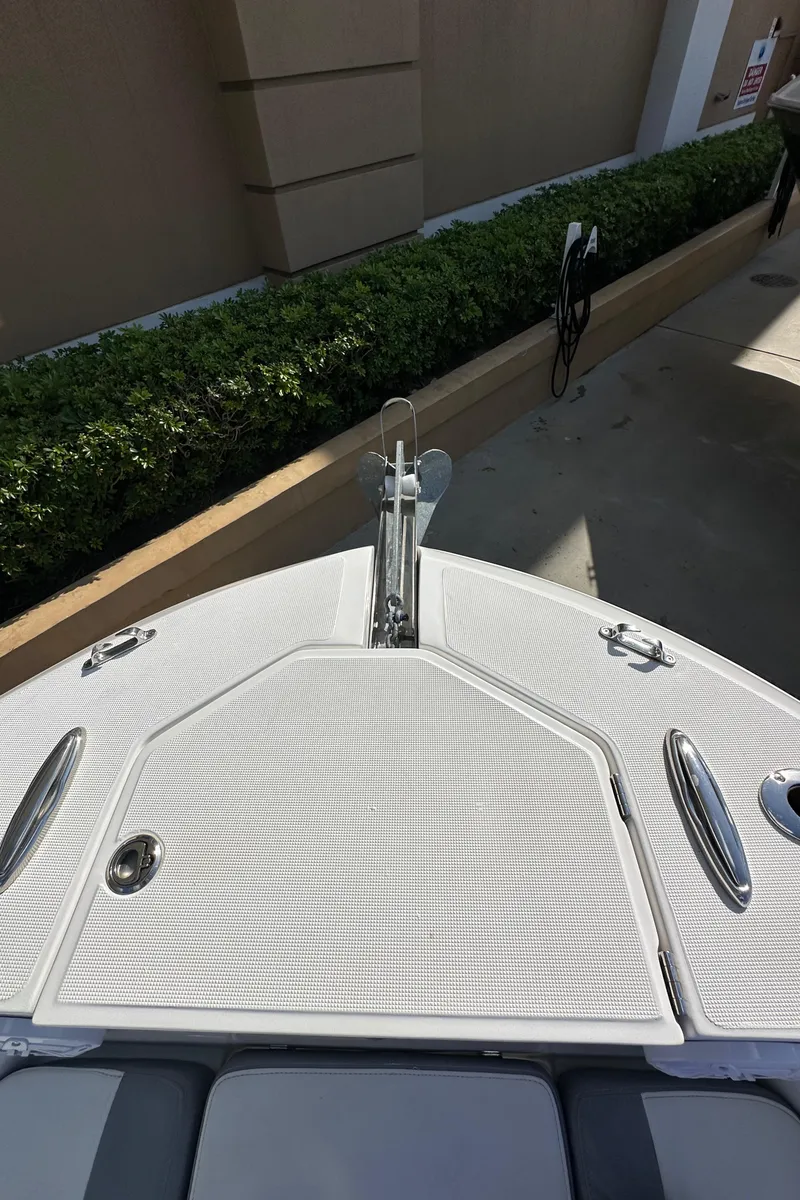 Slide: The Image of 2021 Release 240 RX boat bow with sleek white deck and chrome fittings. - 34