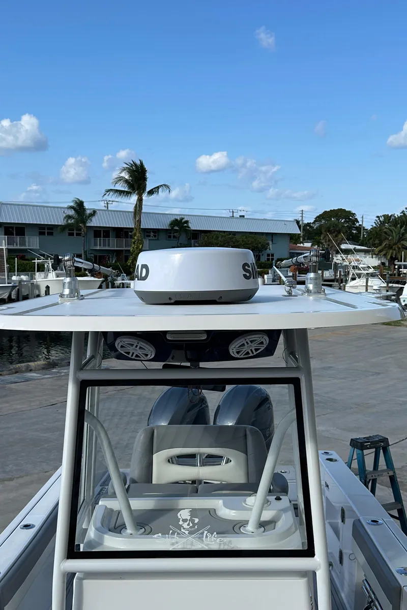Slide: The Image of 2021 Release 240 RX boat with radar, docked under clear blue sky. - 37