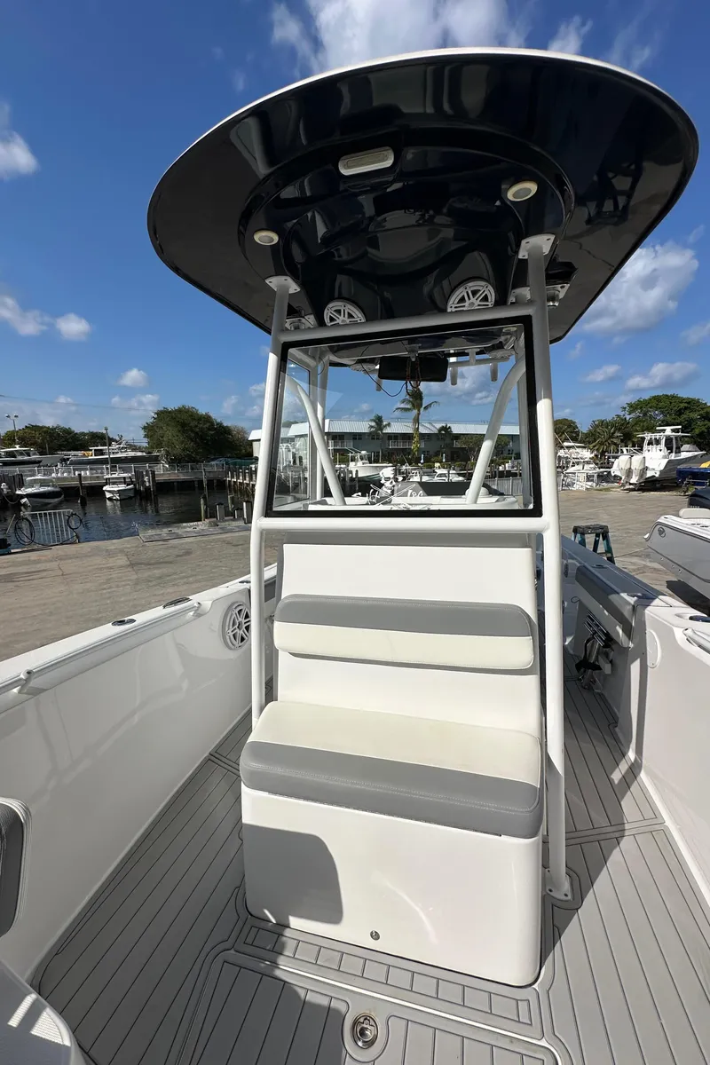 Slide: The Image of 2021 Release 240 RX boat with seating, docked under a clear blue sky. - 38