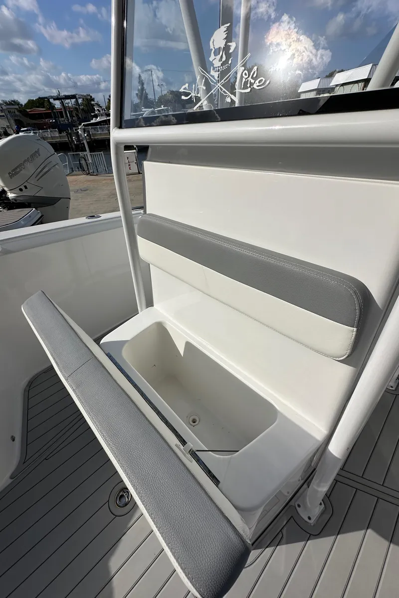 Slide: The Image of 2021 Release 240 RX boat seat with storage compartment, featuring gray and white upholstery. - 39
