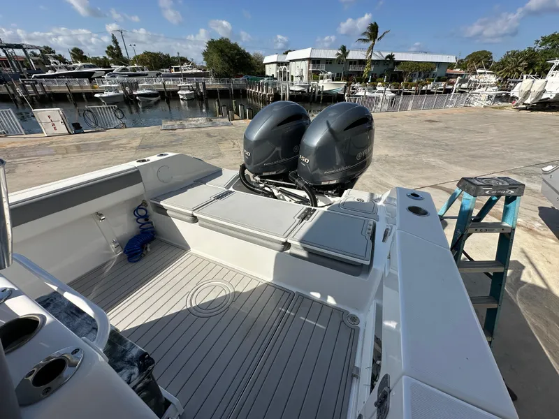 Slide: The Image of 2021 Release 240 RX boat with dual outboard motors docked at a marina. - 5